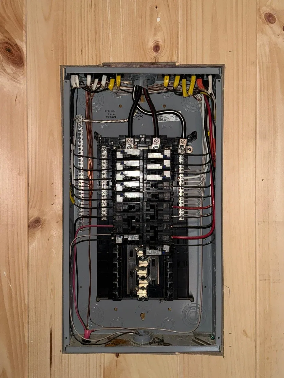 Breaker panel set into a knotty pine wall