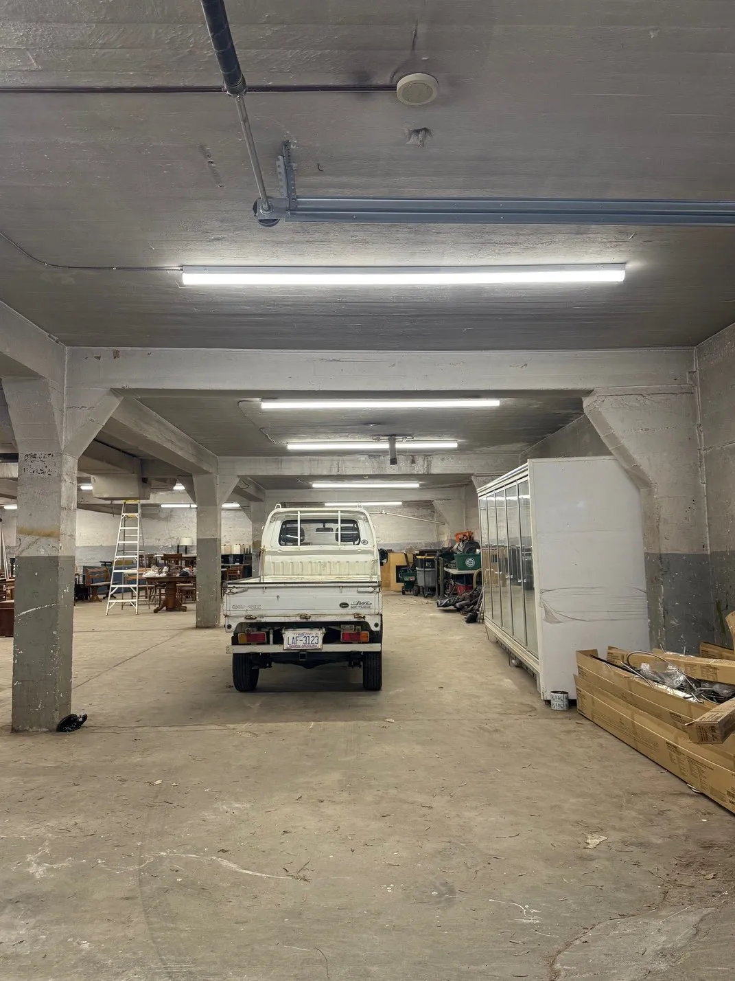 Warehouse lit by rows of long LED fixtures